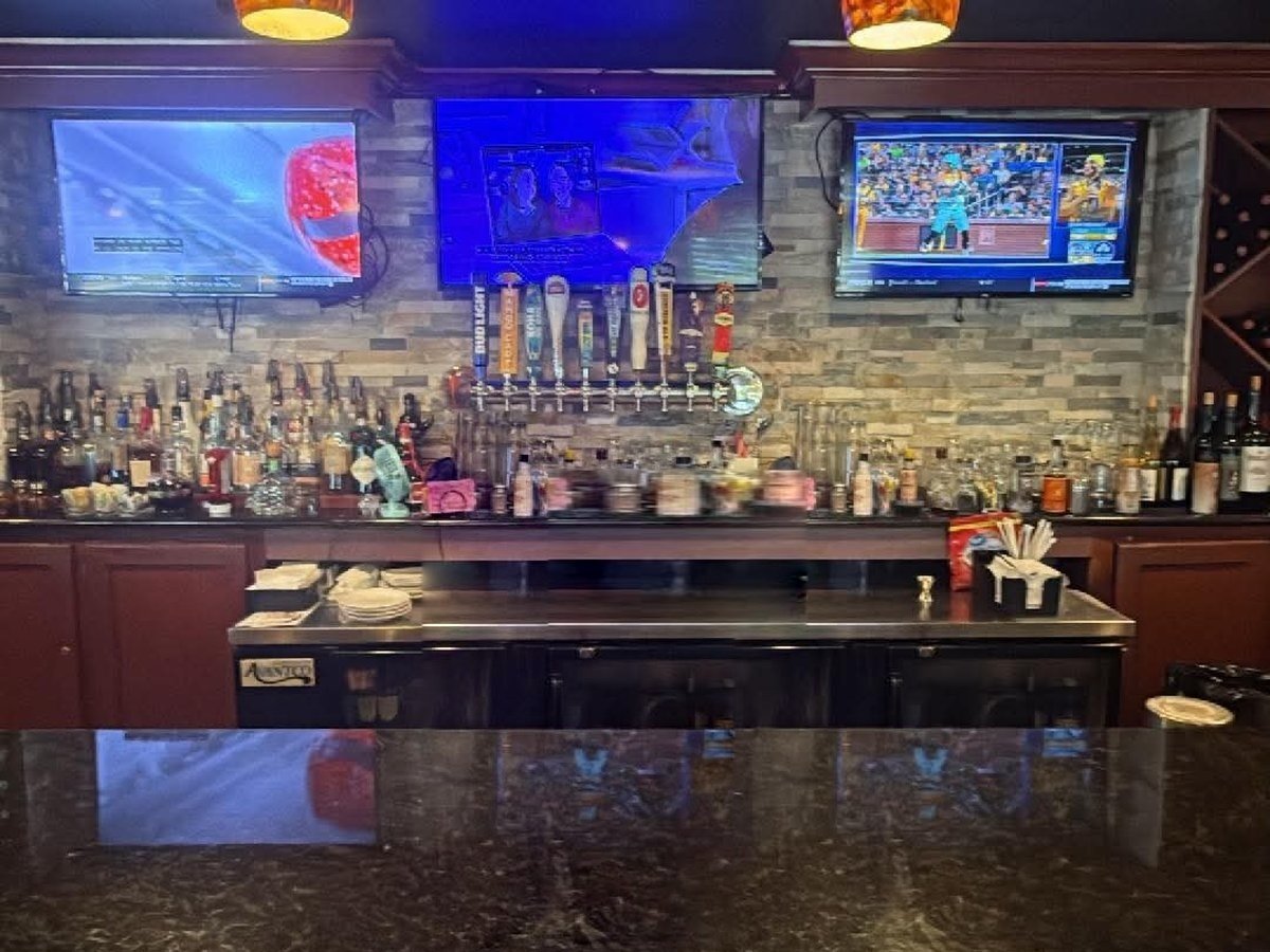 Bartender behind Mama Rosa's full bar