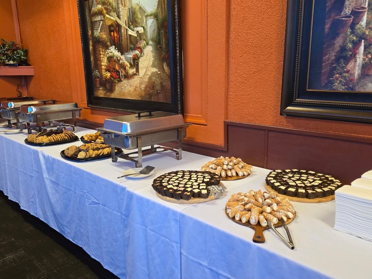 A private event buffet spread at Mama Rosa's with cannoli, cheesecake bites, and cookies