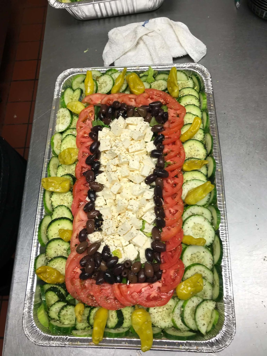 A Greek salad tray with feta & olives