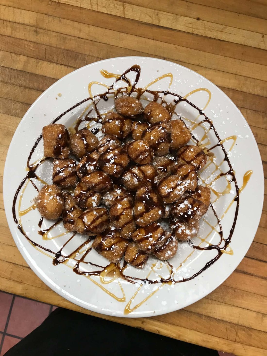 Fried zeppole with chocolate & caramel drizzle