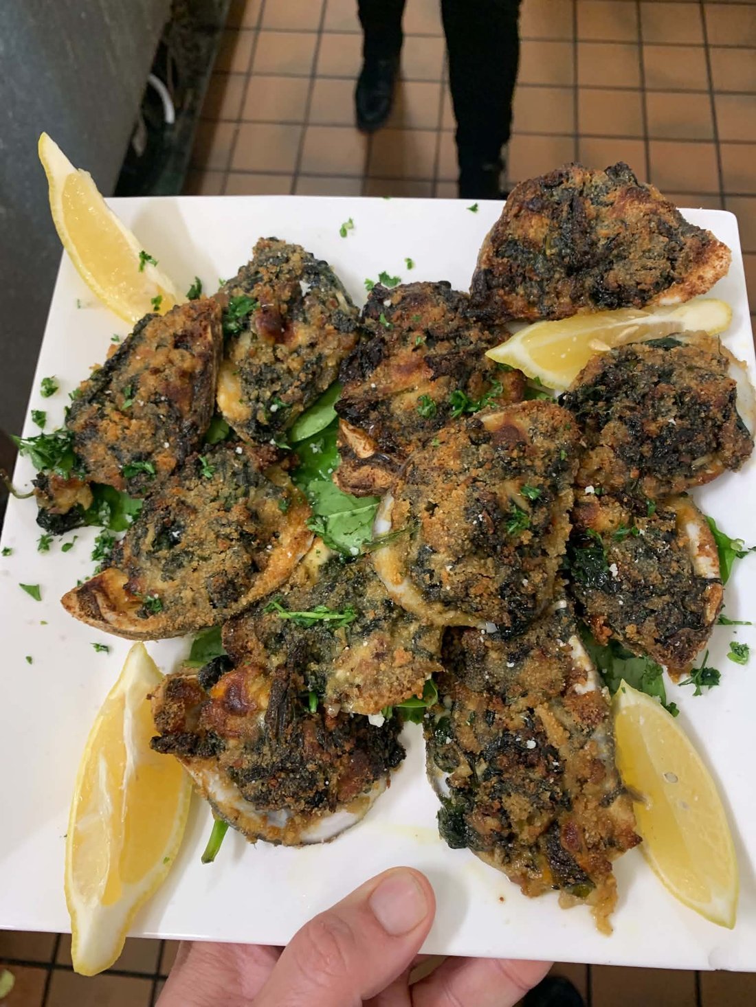 Baked stuffed clams topped with melted cheese